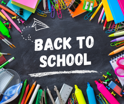 An image of a chalkboard with "BACK TO SCHOOL" written on it, surrounded by school supplies.